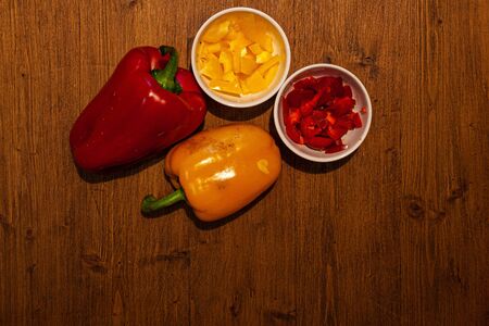 Top view of whole and chopped red and yellow peppers. Concept: food and vegetablesの写真素材