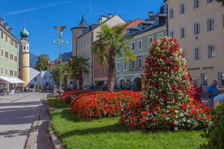 Flowerbed full of red and white flowers and palms in the central square of Lienz