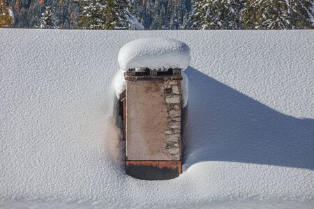 Alpine hut roof with snow-covered fireplace, Val Fiorentina, Dolomites