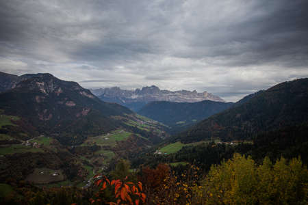 Panorama of Catinaccio Peaks with autumn color in a cloudy day, South Tyrol, Italy. Concept:...