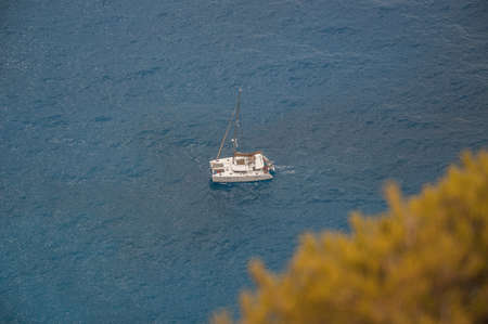 Catamaran sailing on a turquoise sea, Zakynthos island, Greece. Top view