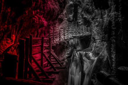 Light and tilt shift effect of stalactites above the walkway in sandstone caves