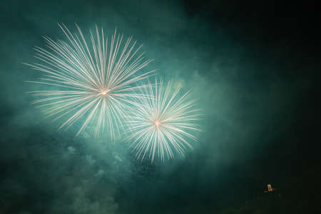 Beautiful white fireworks above a illuminated churchの写真素材