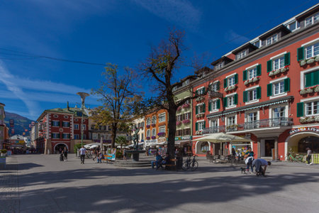 Tourists walking in the central square of Lienz with multi-colored buildingsのeditorial素材