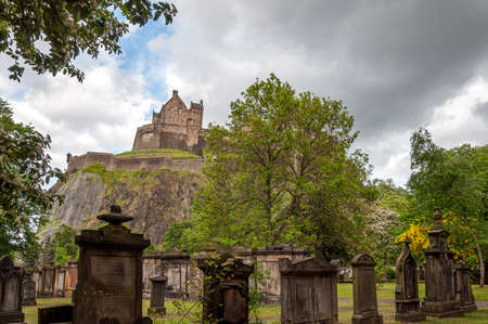 Ancient graveyard tombs with Edinburgh Castle in the backgroundのeditorial素材