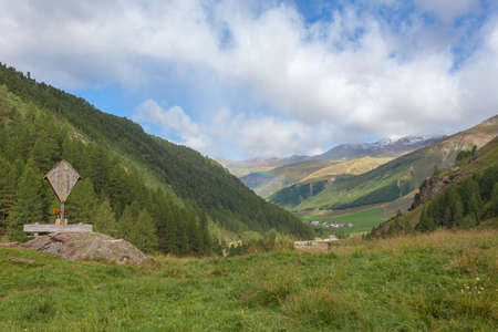 Awesome summer panorama of South Tyrolean valley with rainbowの写真素材