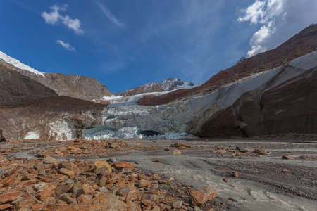 Vallelunga Glacier collapsing tongue with ice caves and turbid stream, Italyの写真素材