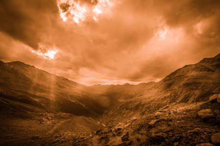 Fantasy color effect of bright sunlight shining through hole of cloudsの写真素材