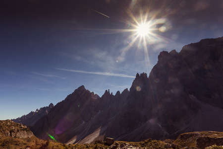 Sun rays over the Dolomite peaks of Popera Mountain in Comelico Regionの写真素材