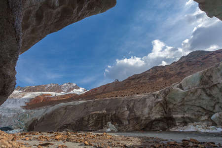 View of glacier tongue from a cave carved into the Vallelunga glacier iceの写真素材