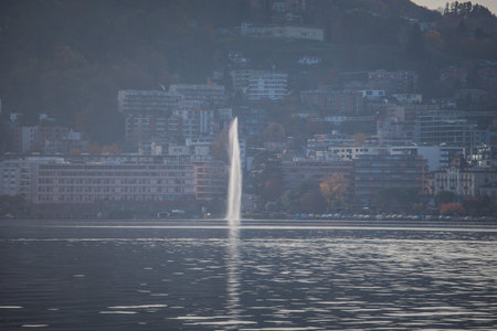 Autumnal panorama of Paradiso lakefront with hotels, resorts and fountainのeditorial素材
