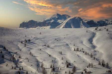 Traces of skiers and snowboarders on white snowy meadows of Fedare, Dolomitesの写真素材
