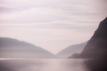 Fantasy pink color effect of Lugano Lake at down, Switzerlandの写真素材