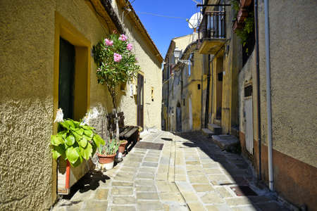 A narrow street among the old houses of Calvello, a medieval village in the Basilicata region,...