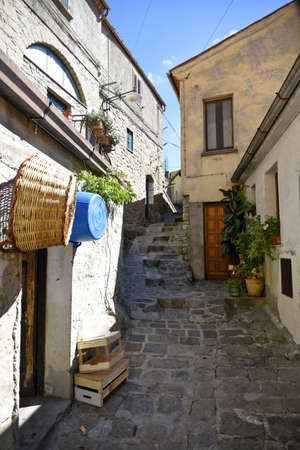 A narrow street among the old houses of Castelmezzano, a medieval village in the Basilicata region,...