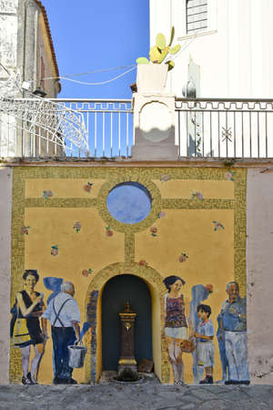 A narrow street embellished with paintings on the walls of San Nicola Arcella, an old town in the Calabria region, Italy.のeditorial素材