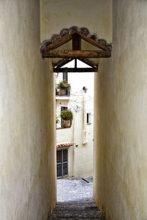 A narrow street among the old houses of Scalea, a medieval village in the Calabria region, Italy.の写真素材