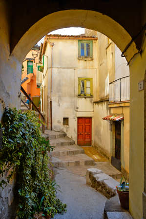 A narrow street among the old houses of Castelcivita, a medieval village in the Campania region,...
