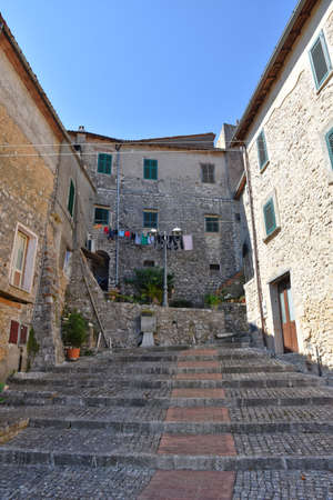 A narrow street among the old houses of Prossedi, a medieval village in the Lazio region, Italy.