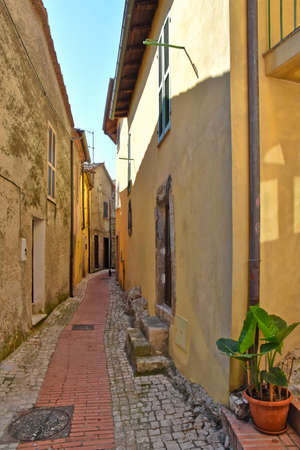 A narrow street among the old houses of Prossedi, a medieval village in the Lazio region, Italy.の写真素材