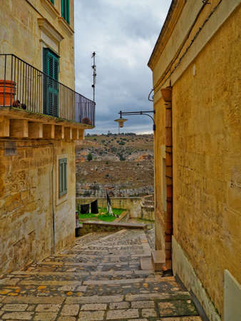 A narrow street among the old houses of Matera, a very ancient city in the Basilicata region, Italy.