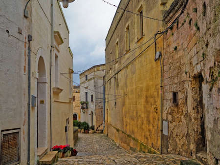 A narrow street among the old houses of Matera, a very ancient city in the Basilicata region, Italy.の写真素材