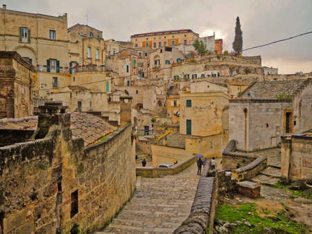 A narrow street among the old houses of Matera, a very ancient city in the Basilicata region, Italy.の写真素材