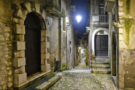 A narrow street between the old houses of Guardia Sanframondi, a medieval village in the province of Salerno, Italy.の写真素材