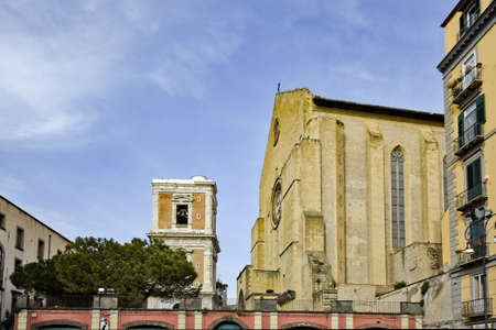 Naples, Italy, May 2, 2021 The bell tower and top of the facade of the Saint Claire cathedral, a historic church in the city.のeditorial素材