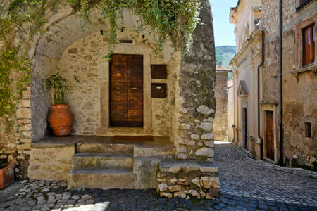 Sermoneta, Italy, 05/10/2021. The entrance door to a medieval house in the historic town.のeditorial素材