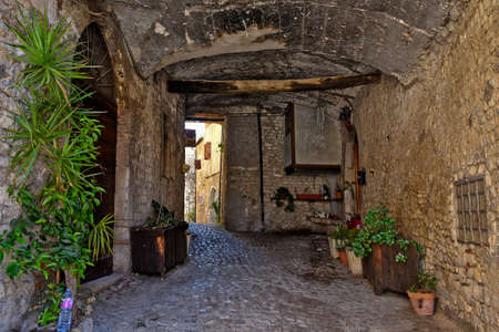 Sermoneta, Italy, 05/10/2021. A street between old medieval stone buildings in the historic town.のeditorial素材