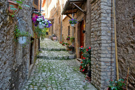 Sermoneta, Italy, 05/10/2021. A street between old medieval stone buildings in the historic town.のeditorial素材