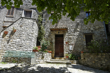 Bassiano, Italy, 05/10/2021. A narrow street between the stone buildings of a medieval town in the Lazio region.のeditorial素材