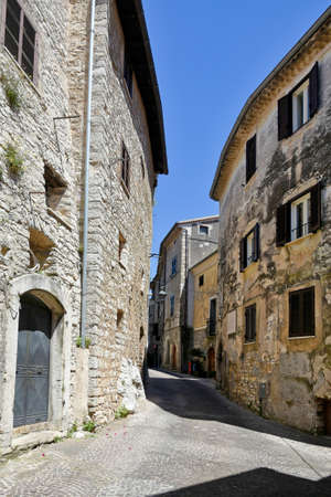 Bassiano, Italy, 05/10/2021. A narrow street between the stone buildings of a medieval town in the Lazio region.のeditorial素材