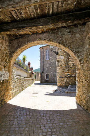 Bassiano, Italy, 05/10/2021. A narrow street between the stone buildings of a medieval town in the Lazio region.のeditorial素材