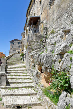Bassiano, Italy, 05/10/2021. A narrow street between the stone buildings of a medieval town in the Lazio region.のeditorial素材