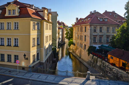 Prague, Czech Republic, 07/29/2015. A river channel between ancient buildings in the historic city center.のeditorial素材