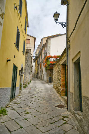 A small street between the old houses of Agnone, a medieval village in the mountains of Molise region in Italy.の写真素材