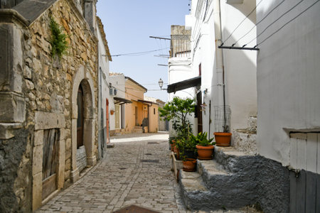 Candela, Italy, June 23, 2021. A small street between the old houses of a mediterranean village of Puglia region.の写真素材