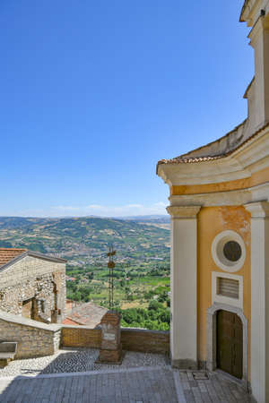 Torrecuso, Italy, July 16, 2021. The door of a church on a small square overlooking the hills.のeditorial素材