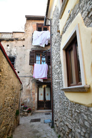 A narrow street among the old stone houses of Taurasi, medieval town in Avellino province.の写真素材