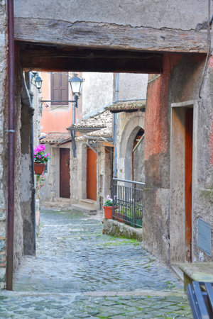 A narrow street between the old houses of Guarcino, a medieval village in the Lazio region.