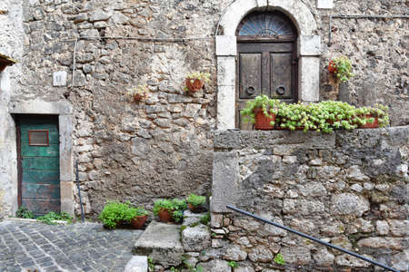 The door of an old house in Guarcino, a medieval village in the Lazio region.のeditorial素材