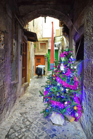 A narrow street between the old houses of Guarcino, a medieval village in the Lazio region.の写真素材