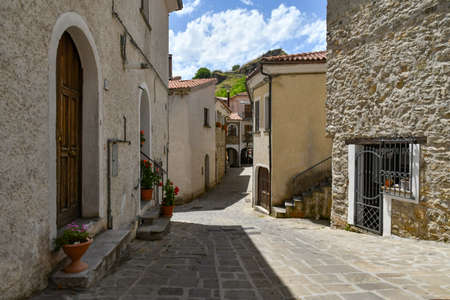 A narrow street between the old houses of Sasso di Castalda, a village in the mountains of Basilicata.の写真素材