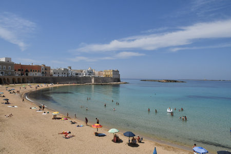 The beach below the old town of Gallipoli, in the province of Lecce, Italy.の写真素材
