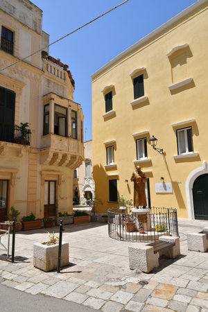 A narrow street between the old houses of Gallipoli, an old village in the province of Lecce in Italy.の写真素材