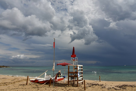 Stormy clouds over a sandy beach of Salento in Puglia region.の写真素材