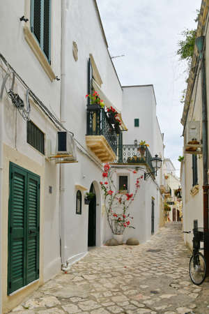 A narrow street among the old houses in the historic center of Otranto, a town in Puglia.の写真素材