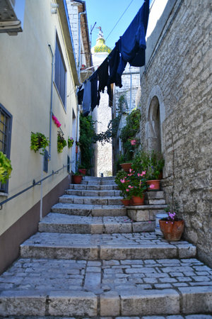 A narrow street between the old stone houses of Oratino, a medieval village in the Molise region.